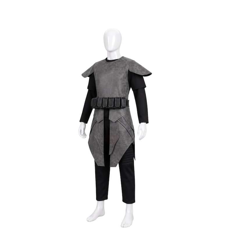 May include: A gray textured armor vest with shoulder pauldrons and a matching utility belt featuring multiple pouches, worn over a black long-sleeved shirt and black trousers on a white mannequin. The armor has a weathered, matte finish.