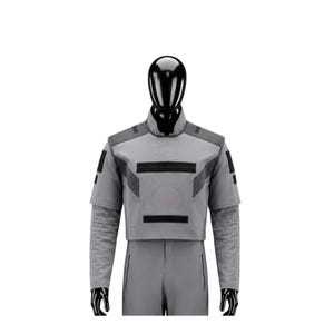 May include: A gray costume with black accents, featuring a high collar and short sleeves. The outfit includes a cropped top with geometric designs and matching pants. The costume is displayed on a black mannequin.