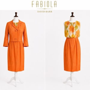 May include: Two vintage dresses on mannequins. The dress on the left is a bright orange suit with a three-quarter sleeve jacket and a knee-length skirt. The dress on the right is a sleeveless orange dress with a floral top. The brand name "FABIOLA" is at the top.