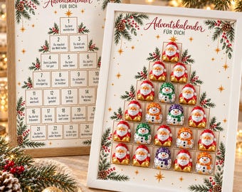 May include: Two framed advent calendars with a Christmas tree design. One frame contains text in boxes numbered 1 to 24, while the other features chocolate figures of Santa Claus and snowmen arranged in a tree shape under the text Adventskalender.