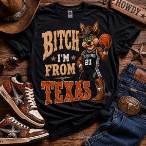 May include: Black t-shirt with the text "Bitch I'm From Texas" and a cartoon coyote wearing a cowboy hat and Spurs basketball uniform. The image includes a basketball, jeans, sneakers, and a cowboy hat.