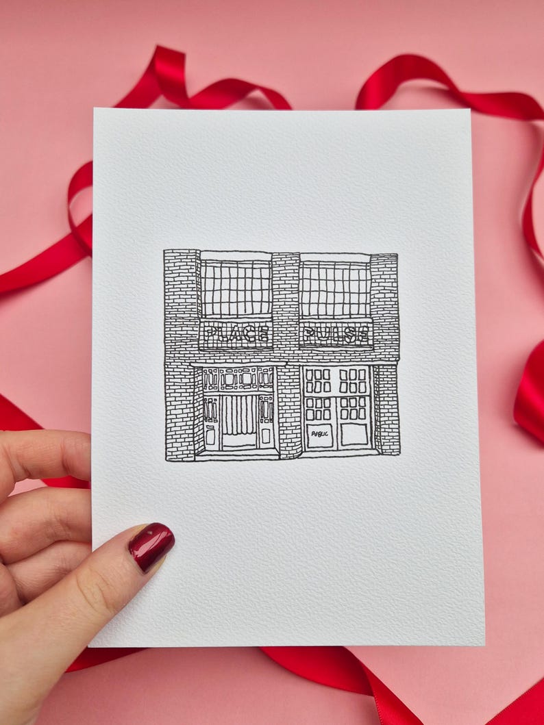 May include: Black and white line drawing of a building with the words "PLACE" and "PULSE" above the windows. The building has a brick facade and multiple windows and doors. The drawing is on a white card, with a pink background and red ribbon.