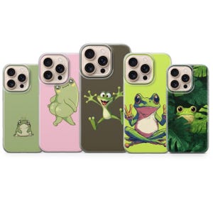 May include: A collection of five phone cases featuring cartoon frog designs. The cases showcase various frog illustrations, including a frog with a peace sign, a frog in leaves, and other playful frog characters. The cases are in shades of green, pink, and brown.