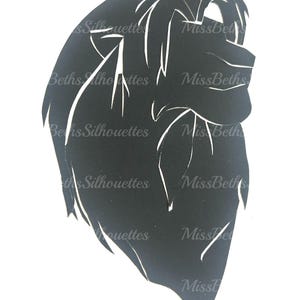 May include: A black silhouette of a lion's head, cut from a single piece of material. The mane and facial features are defined by negative space. The text "Beths Silhouettes" and "Miss Beths" are visible.