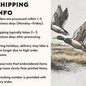 May include: A graphic illustration of two mallard ducks in flight over a marshy landscape. The ducks feature detailed plumage in shades of brown, white, and green, with wings spread wide against a light-colored background. The scene captures the birds mid-flight above a grassy wetland area with water visible in the foreground.
