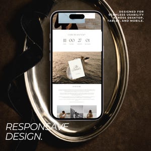 May include: A smartphone displaying a wedding website design on a silver platter. The website features a countdown, the words "The Details", and the text "Responsive Design. Designed for seamless usability across desktop, tablet, and mobile."