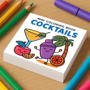 May include: A stack of mini coloring books with the title "Mini Coloring Book Cocktails" is surrounded by colored pencils and markers. The cover features cartoon illustrations of cocktail-related images, including a martini glass and a cocktail shaker.