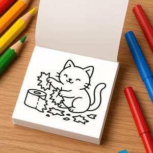 An open mini coloring book page shows a black and white line drawing of a cat unrolling toilet paper.