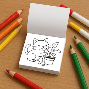 An open mini coloring book displays a line-art illustration of a cute cat nibbling on the leaf of a potted houseplant.