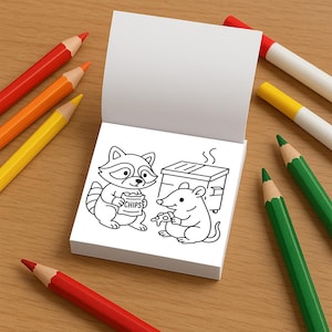 May include: A coloring book with a raccoon and mouse illustration, holding chips and pizza, respectively. The book is open, surrounded by red, orange, yellow, and green colored pencils and markers on a wooden surface.