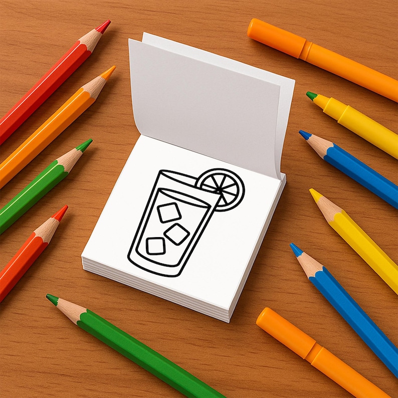May include: A drawing of a beverage with ice and a lemon slice on a white notepad. The notepad is surrounded by colorful pencils and markers in shades of red, orange, yellow, green, and blue, arranged on a wooden surface.