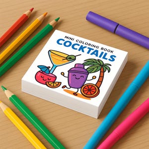 A mini coloring book titled Cocktails displays a cover with cartoon illustrations of a martini glass with an olive, a cocktail shaker with a palm tree, and a drink with an umbrella.