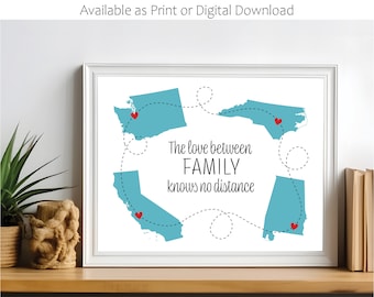 May include: A white framed print with a blue map of the United States showing four states connected by dashed lines. The states are Washington, North Carolina, California, and Alabama. The text "The love between FAMILY knows no distance" is printed in black below the map. Red hearts are placed on each state.