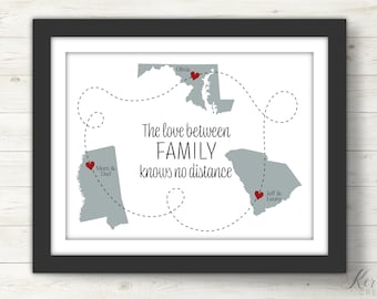 May include: A framed print with a map of the United States showing three locations with red hearts and the text "The love between FAMILY knows no distance".