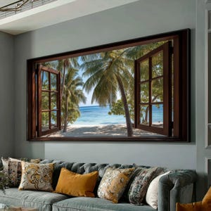以下が含まれることがあります： 熱帯のビーチの景色が見える開いた窓を描いた額入りの壁の芸術作品。窓枠は濃い茶色で、ヤシの木、白い砂浜、青い海が晴れた空の下に広がっています。このアートワークは、灰色のソファの上に飾られています。