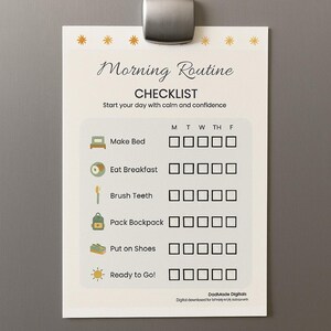 May include: A white checklist titled "Morning Routine" with a magnetic clip. The checklist includes tasks like "Make Bed" and "Eat Breakfast" with checkboxes for each day of the week. The text "Start your day with calm and confidence" is also included.