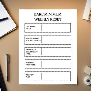 May include: A white paper planner sheet titled BARE MINIMUM WEEKLY RESET with five sections for This Weeks Focus, Appointments/Non-Negotiables, Meals I Can Realistically Make, One Thing For Myself, and What Can Wait, each featuring a dashed border.