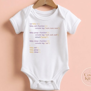 May include: A white short-sleeved baby bodysuit featuring printed JavaScript code in purple and yellow text. The code defines functions for baby behaviors including eat, poop, and sleep, with console log outputs like nom, wah, and zzz. Three metal snaps are visible at the bottom.