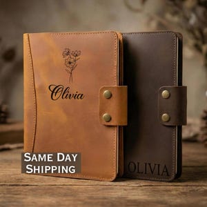 May include: Two leather journals, one tan and one brown, with a snap closure. The tan journal has a floral design and the name "Olivia" engraved. The brown journal also has "Olivia" engraved. The text "SAME DAY SHIPPING" is visible on the tan journal.