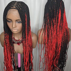 May include: A black and red braided wig displayed on a mannequin head. The wig features long, box braids with a gradient effect, transitioning from black at the roots to vibrant red at the ends. The wig is styled with a lace front and is shown from the front and back.