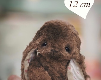May include: A brown plush bunny, approximately 4.7 inches (12 cm) tall, with floppy ears and a sweet expression. The ears have a pink heart pattern on the inside. The text "PDF PATTERN" is at the bottom.