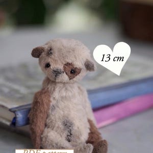 May include: A handmade teddy bear with a heart-shaped patch over one eye. The bear is approximately 5 inches tall and has brown and cream-colored fur. The image includes the text "PDF pattern".