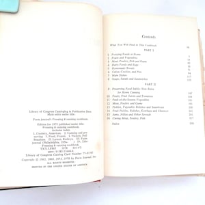May include: An open cookbook titled Farm Journal's Freezing & Canning Cookbook. The left page displays Library of Congress cataloging data and copyright information. The right page shows the table of contents listing sixteen chapters.