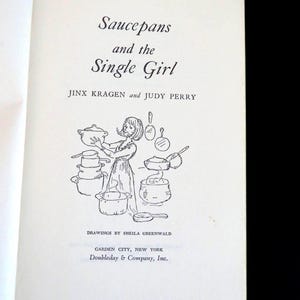 May include: The title page of the book Saucepans and the Single Girl by Jinx Kragen and Judy Perry, with drawings by Sheila Greenwald. It features a black ink line drawing of a person surrounded by various cooking pots and pans, published by Doubleday & Company, Inc. in Garden City, New York.
