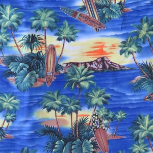 May include: A blue and green tropical print fabric with palm trees, surfboards, and a sunset over a mountain in the distance. The surfboards have the word "SURF" printed on them.
