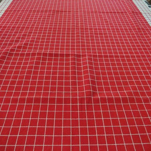 May include: Red and white checkered tablecloth with a white border. The tablecloth is made of a woven fabric and has a smooth texture.