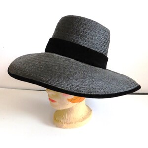 May include: A wide-brimmed gray straw hat with a black velvet band.