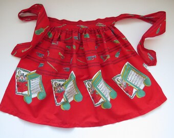 1960s Christmas Half Apron - Carolers Musical Instruments Notes - Vintage Red Novelty Holiday Apron - Holiday Entertaining Baking - Gift