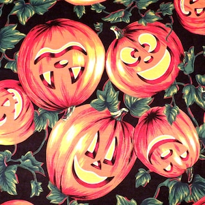 May include: A fabric pattern featuring orange jack-o'-lanterns with carved faces and yellow glowing eyes and mouths, interspersed with green vine leaves against a solid black background. The pumpkins display various expressions.