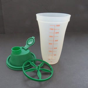 May include: A set of three ceramic nesting bowls in graduating sizes. The bowls feature a speckled, cream-colored exterior and a contrasting dark brown interior. The largest bowl measures approximately 8 inches in diameter.