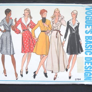May include: Vogue's Basic Design sewing pattern featuring illustrations of five different dress designs. The dresses are in various colors and styles, including a checkered dress, a red floral wrap dress, and a black dress with white lapels. The pattern number is 2764.
