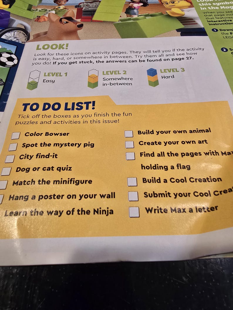 May include: A printed activity page featuring a yellow TO DO LIST section with checkboxes next to tasks like Color Bowser, Spot the mystery pig, City find-it, Dog or cat quiz, Match the minifigure, Hang a poster, and Learn the way of the Ninja.