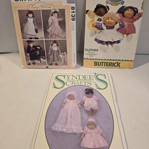 May include: Three sewing pattern envelopes featuring illustrations of dolls and clothing. The top left is McCall's Crafts 8139 for Betsy McCall. The top right is Butterick 6509 for Cabbage Patch Kids. The bottom is Syndee's Crafts 24020 for a 12" baby doll.