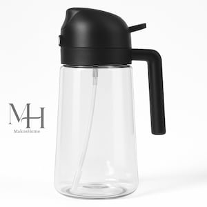 May include: A clear glass oil dispenser with a black lid, handle, and pump. The dispenser has a long, thin spout and the text "MH MakosHome" on the side. The dispenser is designed for easy pouring and dispensing of liquids.