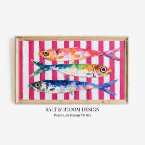 May include: A framed artwork featuring three colorful fish painted in an impressionistic style. The fish are set against a background of vertical pink and white stripes. The artwork is labeled "SALT & BLOOM DESIGN Premium Frame TV Art."