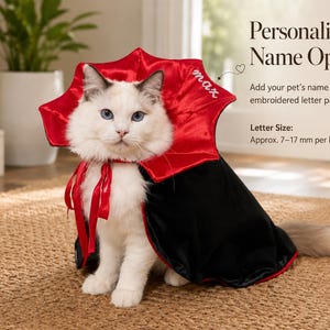 May include: A white cat wearing a black and red satin cape with a high, flared collar. The collar features the embroidered name max. Text on the image reads Personalized Name Option, Add your pet's name with embroidered letter patches, Letter Size: Approx. 7-17 mm per letter.