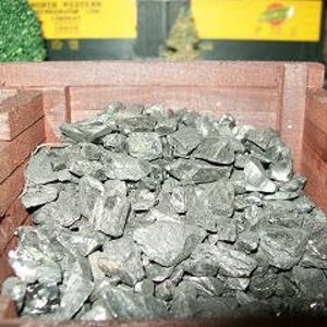 May include: A wooden coal bin filled with black coal chunks.
