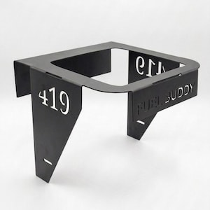 May include: Black metal Fuel Buddy with the number 419 in white. The product has a square top with a curved front and two angled supports. The words "FUEL BUDDY" are cut out of the metal.