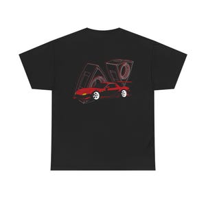May include: Black t-shirt featuring a red sports car graphic with white wheels and a red outline of an engine. The design is on the front of the shirt. The shirt is made of a soft, comfortable material.