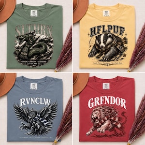 May include: Four t-shirts with different designs. One is green with a snake and the word "SLTHRN". Another is yellow with a badger and the word "HFLPUF". A third is blue with an owl and the word "RVNCLW". The last is red with a lion and the word "GRENDOR".