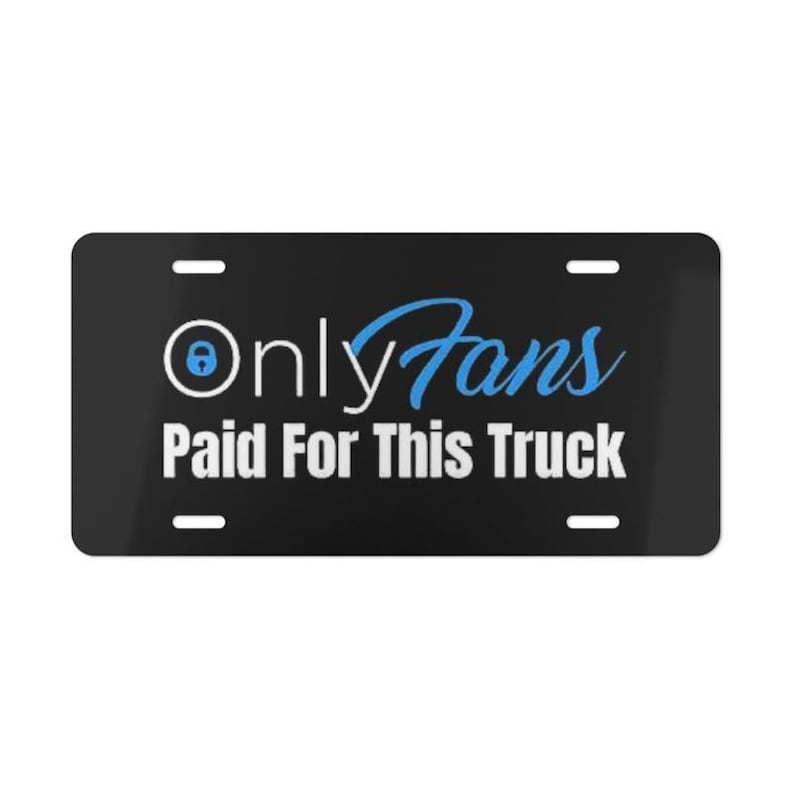 May include: Black license plate with the text "OnlyFans Paid For This Truck" in white and blue. The OnlyFans logo is in the upper left corner. The plate has four mounting holes.