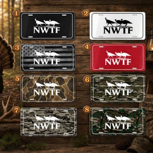 May include: Collection of license plates with the NWTF logo, featuring turkey silhouettes. Plates come in various designs, including black, white, red, camouflage, and an American flag pattern. Each plate has the NWTF text.