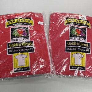 May include: Two red Fruit of the Loom Pocket-T shirts in plastic packaging. The shirts are a 50/50 blend of cotton and polyester.