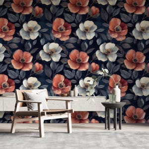 May include: A floral wallpaper design featuring large, watercolor-style flowers in shades of red, white, and cream against a dark blue background. The flowers are surrounded by gray leaves, creating a repeating pattern. The image also shows a wooden chair, a side table, and a white cabinet.
