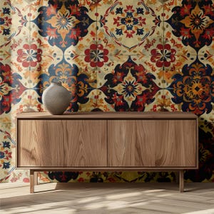 May include: A wooden cabinet with two doors and a small, gray vase on top. The cabinet is made of light brown wood and has a simple, modern design. The background is a colorful patterned wall with floral motifs in red, blue, and orange.