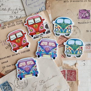 May include: A collection of colorful, retro-style van stickers. The vans feature various designs, including floral patterns, peace signs, and the word "LOVE." The stickers are in shades of pink, purple, blue, and yellow, evoking a vintage, bohemian aesthetic.